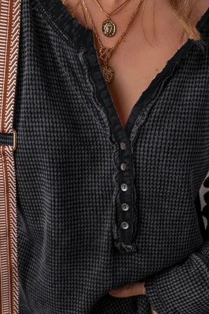 Black waffle knit henley blouse with button detail and v-neck
