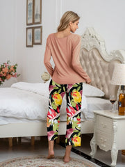 Botanical print lounge set with long sleeve top in dusty pink and cropped pants in vibrant floral pattern.