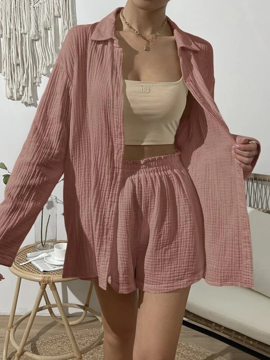 Pink textured gauze shirt and shorts set with buttoned long sleeves and elastic waist shorts.