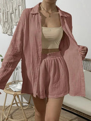 Pink textured gauze shirt and shorts set with buttoned long sleeves and elastic waist shorts.