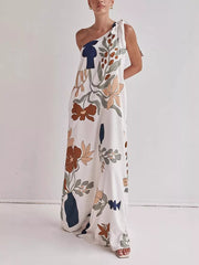 One-shoulder maxi dress with abstract floral print and tie detail.