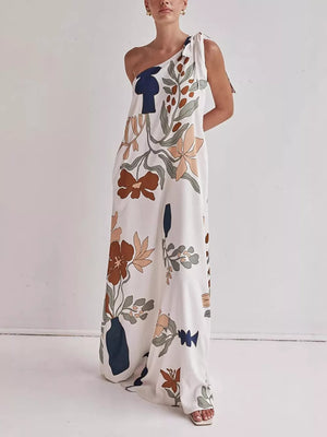 One-shoulder maxi dress with abstract floral print and tie detail.