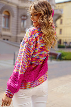 Colorblock marled knit sweater with balloon sleeves in hot pink and multicolor stripes.