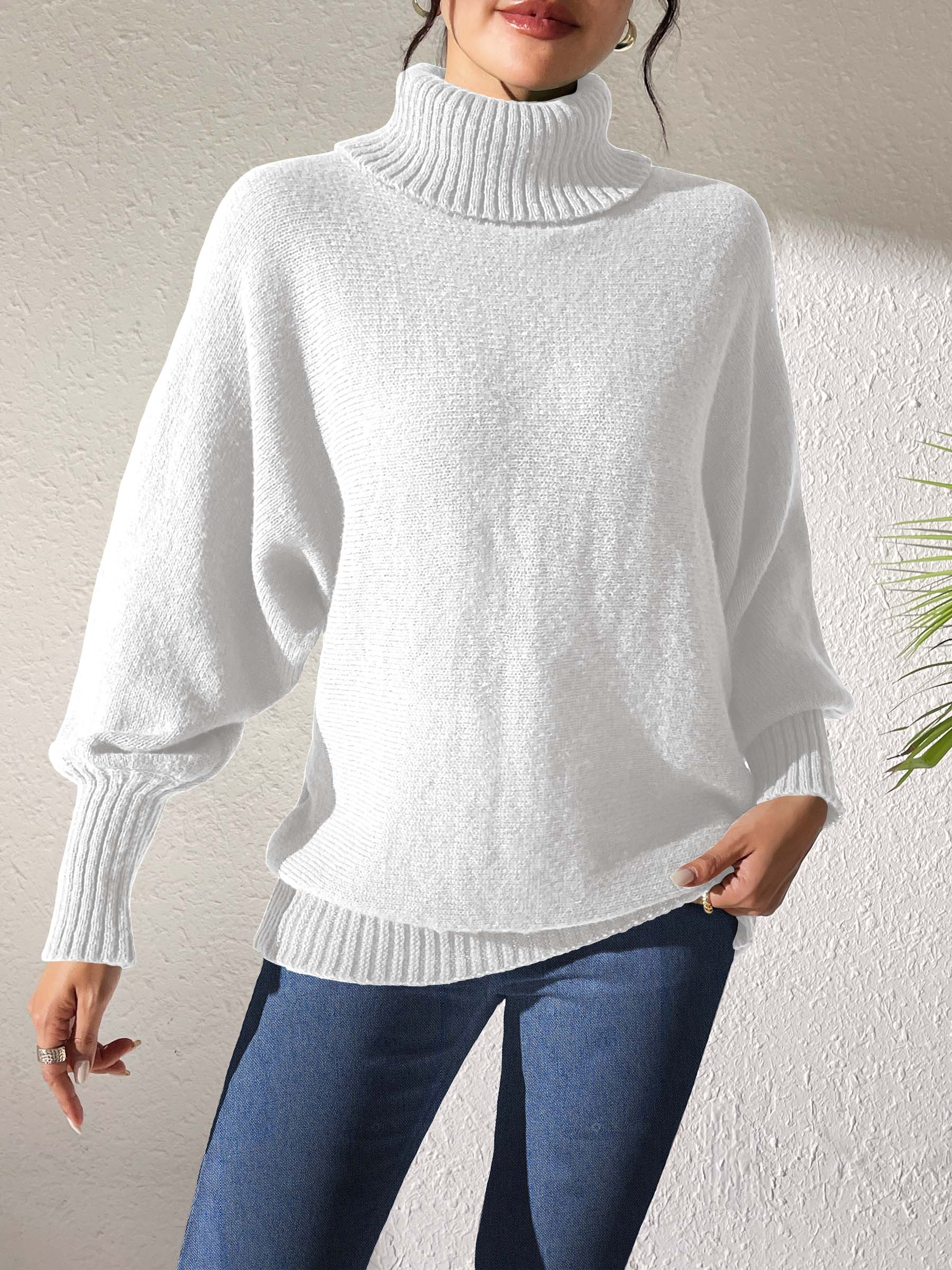 White balloon sleeve turtleneck sweater with relaxed knit and ribbed cuffs.