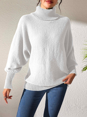 White balloon sleeve turtleneck sweater with relaxed knit and ribbed cuffs.