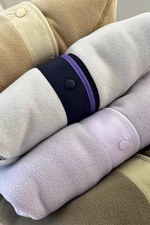 Fleece bomber jacket with contrast trim, snap button details, and plush texture.