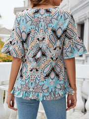 Light blue paisley print blouse with ruffle hem and flutter sleeves.