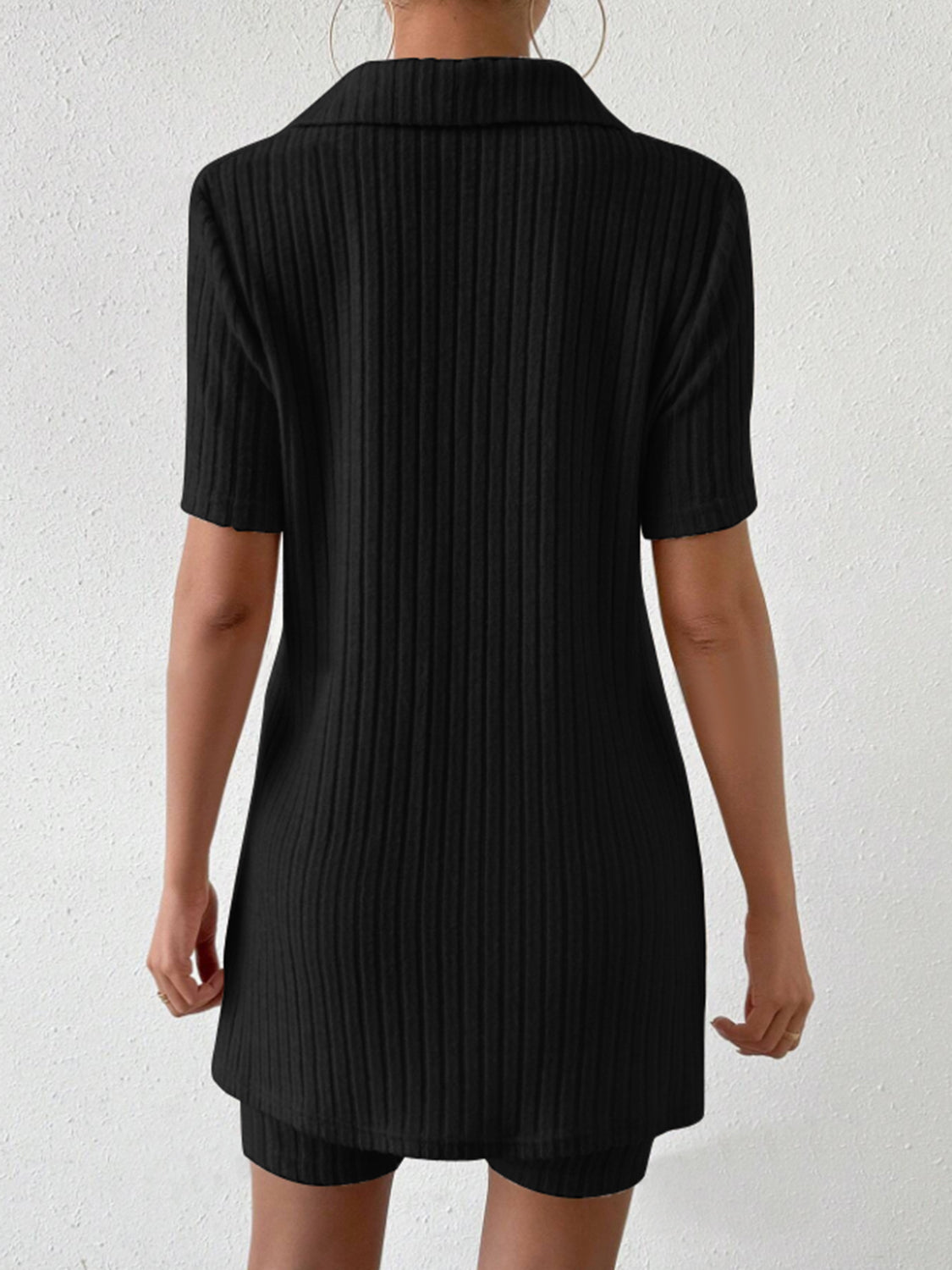 Black ribbed polo shirt and shorts set with short sleeves and a collar.