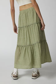 Tiered cotton maxi skirt in matcha green with ruffled tiers.