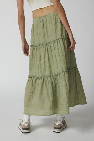 Tiered cotton maxi skirt in matcha green with ruffled tiers.
