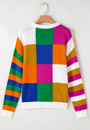 Patchwork knit crewneck pullover sweater with bold color blocks and striped sleeves.