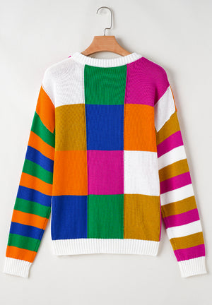 Patchwork knit crewneck pullover sweater with bold color blocks and striped sleeves.