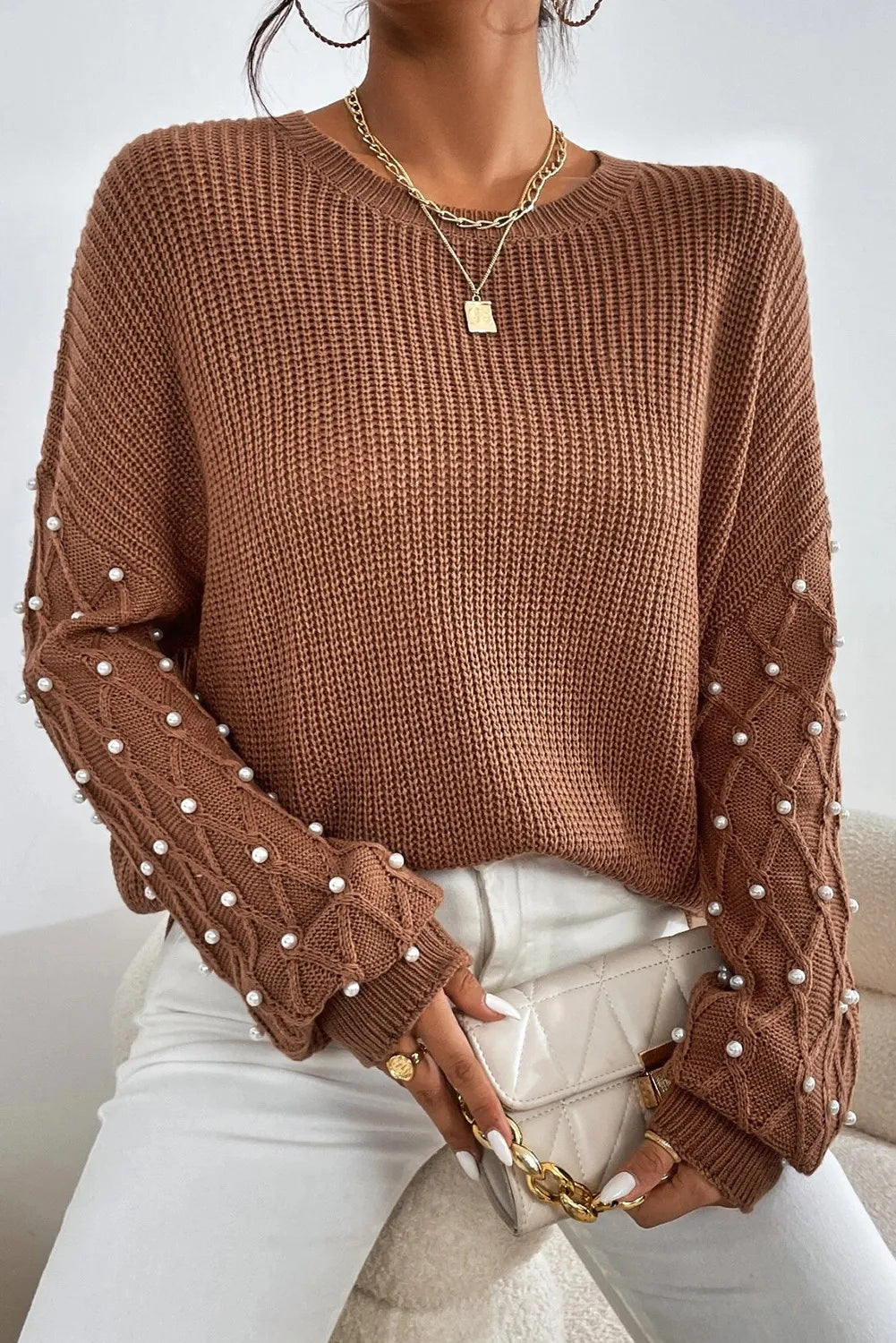 Brown cable knit sweater with pearl embellishments on sleeves, crew neck, long sleeves.