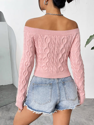 Blush pink cable knit off-the-shoulder cropped sweater with long sleeves.