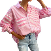 Pink and white striped oversized button-down shirt with a pocket and cuffed sleeves.