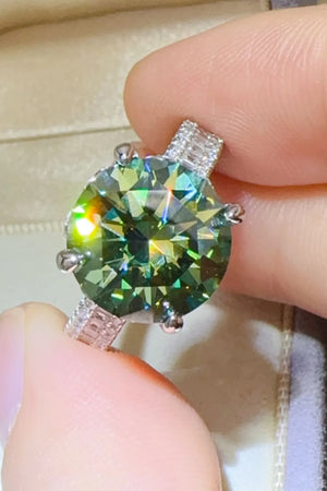 Emerald cut halo engagement ring in dark green sterling silver with baguette accents.