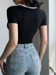 Black maternity crop t-shirt with white contrast trim neckline and short sleeves.