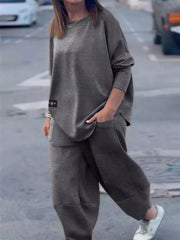 Dark gray crew neck two-piece lounge set with pockets and a casual fit.