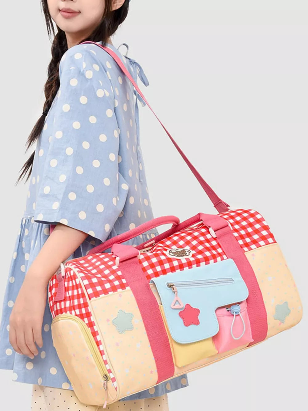 Charming red gingham duffel bag with colorful pockets and star details.