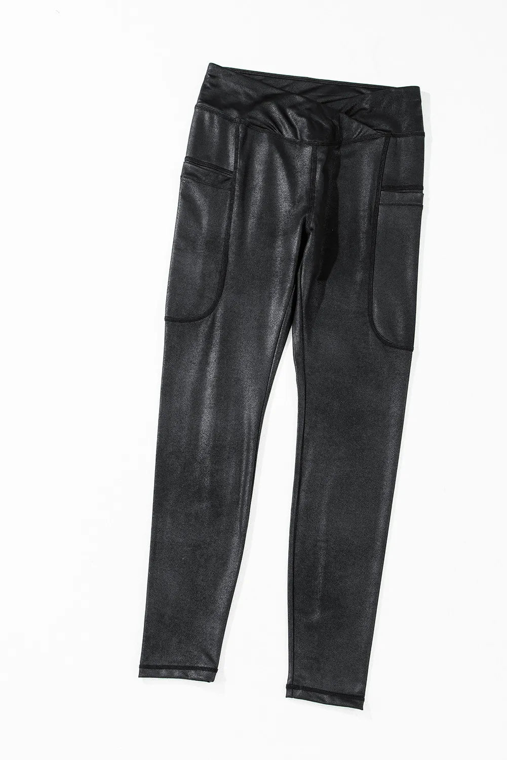 Black faux leather leggings with textured finish and side pockets.