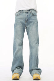 Wide leg denim bell bottom jeans in medium wash, styled with yellow sneakers.