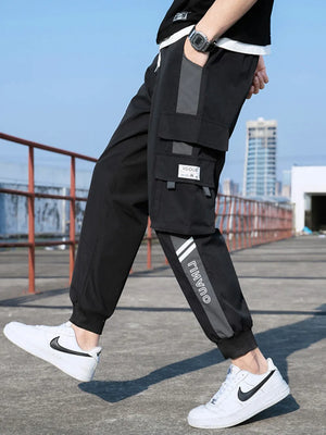 Black cargo joggers with stylish gray accents and white stripe detail on leg.