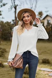 White waffle knit blouse with eyelet detail and ruffled cuffs