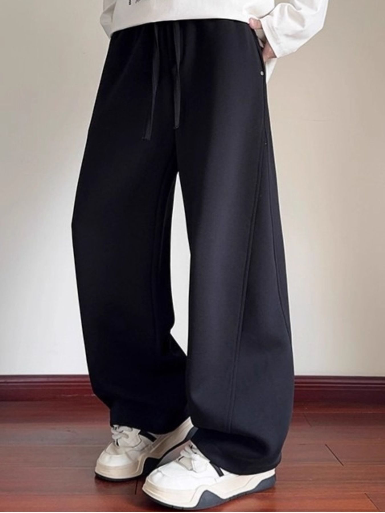 Men's black drawstring wide-leg sweatpants with a comfortable casual fit.