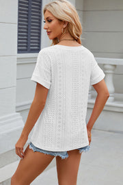White perforated pocket tee with rolled sleeves and a casual fit.