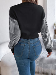 Black cropped knit sweater with geometric stripe sleeves and V-neck