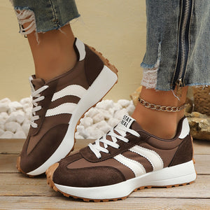 Brown lace up round toe sneakers with white stripes and chunky sole.
