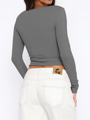 Gray ribbed button-down crop top with long sleeves.