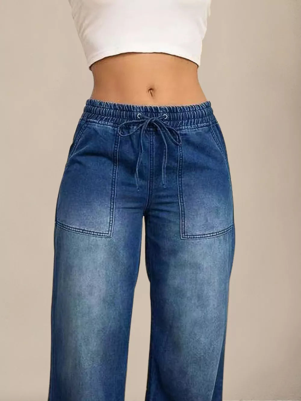 Light blue denim maternity jeans with drawstring waist and wide legs.
