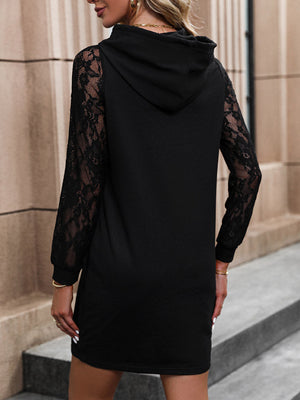 Black hooded mini dress with lace sleeves and a casual cut.