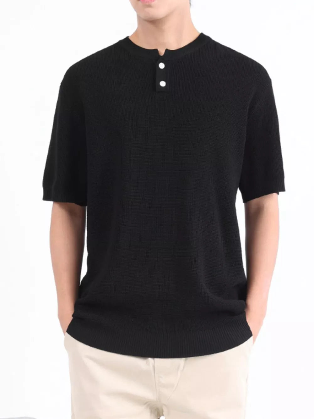 Black textured knit short sleeve henley with two white buttons.