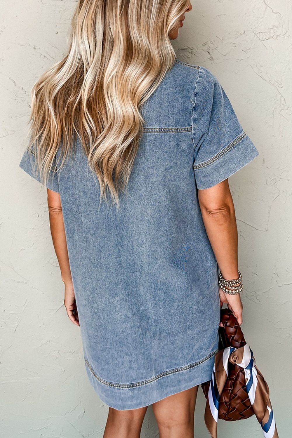 Light blue denim mini dress with short sleeves and a casual fit.