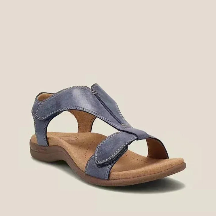 Navy leather T-strap comfort sandals with adjustable straps and a cushioned footbed.