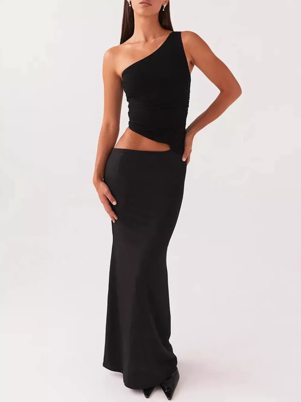 Black one-shoulder cutout maxi dress with a fitted skirt.
