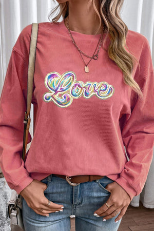 Burnt coral corduroy sweatshirt with sequin "Love" appliqué and crew neck.