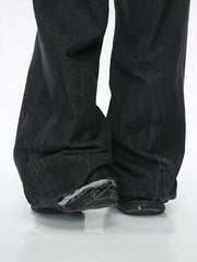 Dark denim palazzo trousers with distressed hem detail.