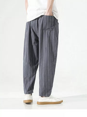 Men's grey striped relaxed fit sweatpants with drawstring and pockets.