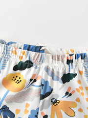 Toddler pants with elastic waistband and whimsical floral print in blue, yellow, and orange on white cotton.