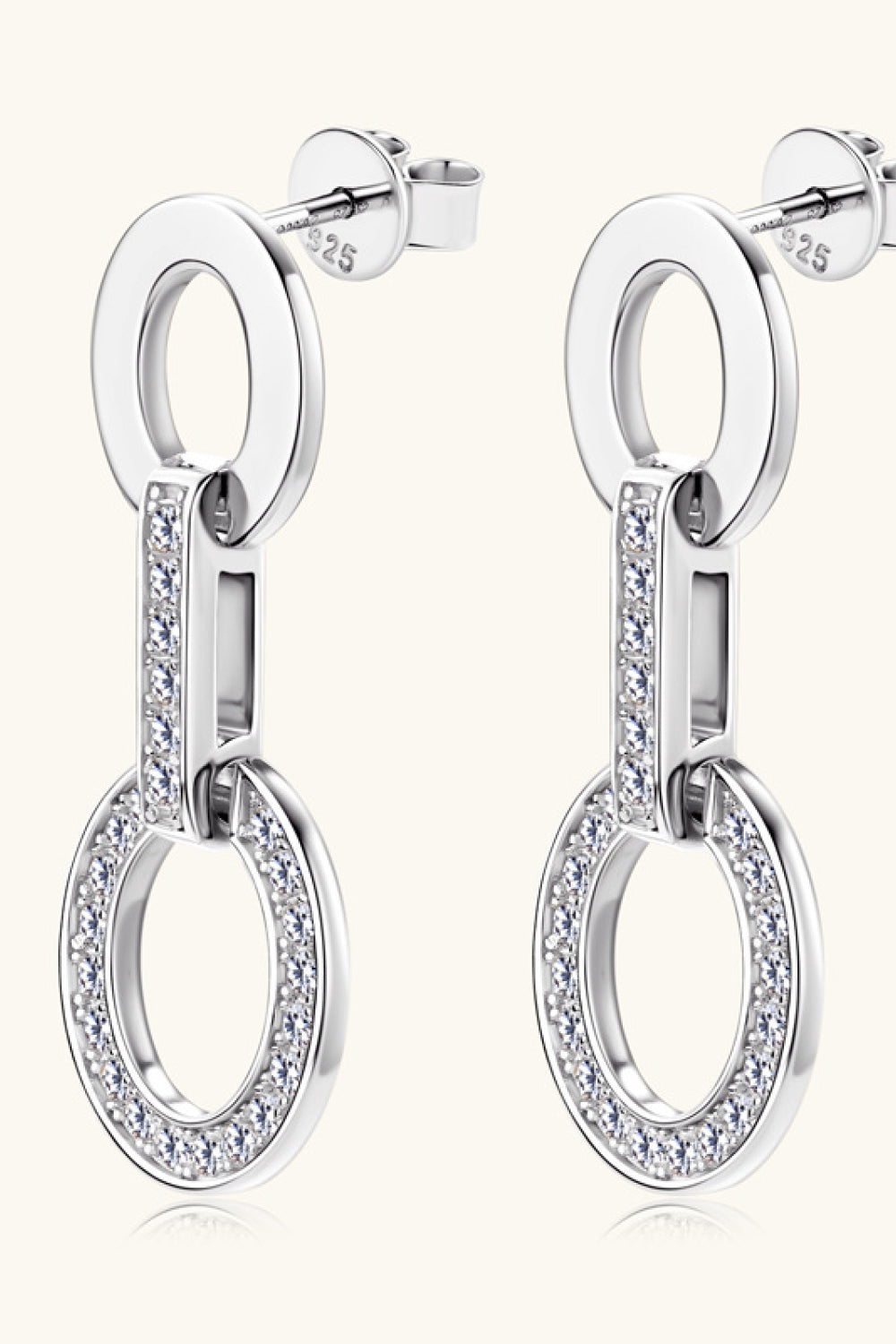 Silver geometric pavé drop earrings with oval links and sparkling stones.