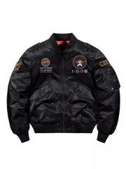 Men's black zip-up bomber jacket with embroidered patches and utility pocket.
