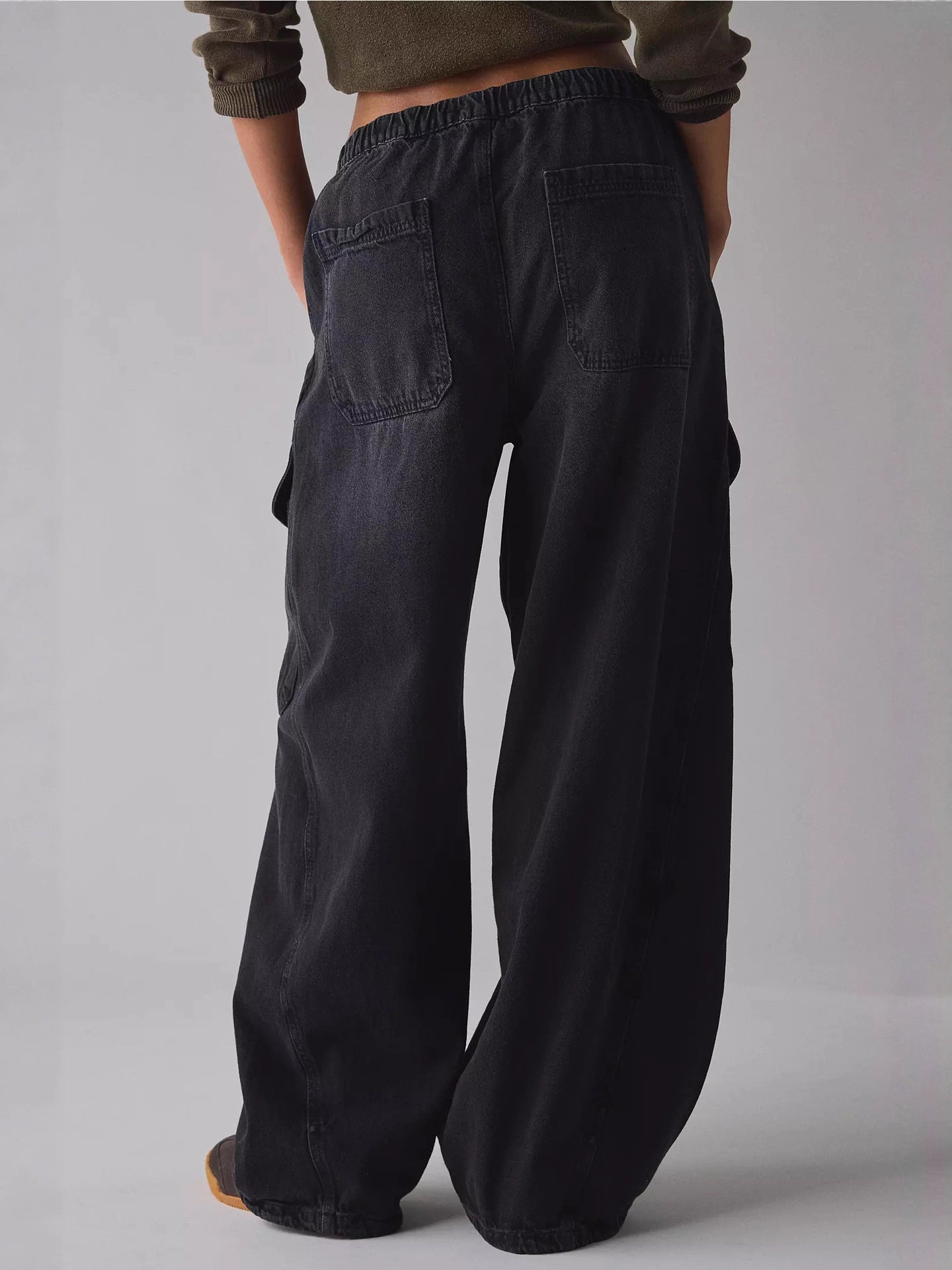 Black drawstring waist wide leg cargo jeans with multiple pockets.