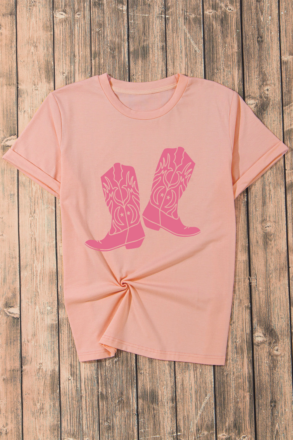 Blush pink graphic tee with round neck and cowboy boot print