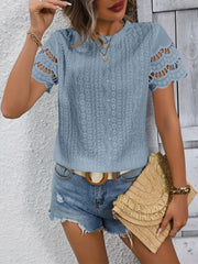 Light Blue eyelet blouse with scalloped short sleeves and intricate patterned fabric.