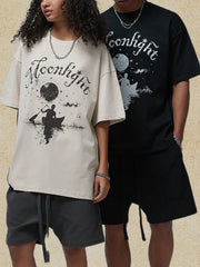 Ivory oversized graphic tee with moonlight canoe print and black oversized graphic tee with moonlight print