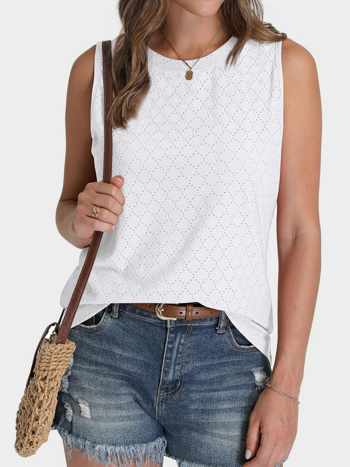 Textured sleeveless shell top in white with a geometric eyelet pattern.