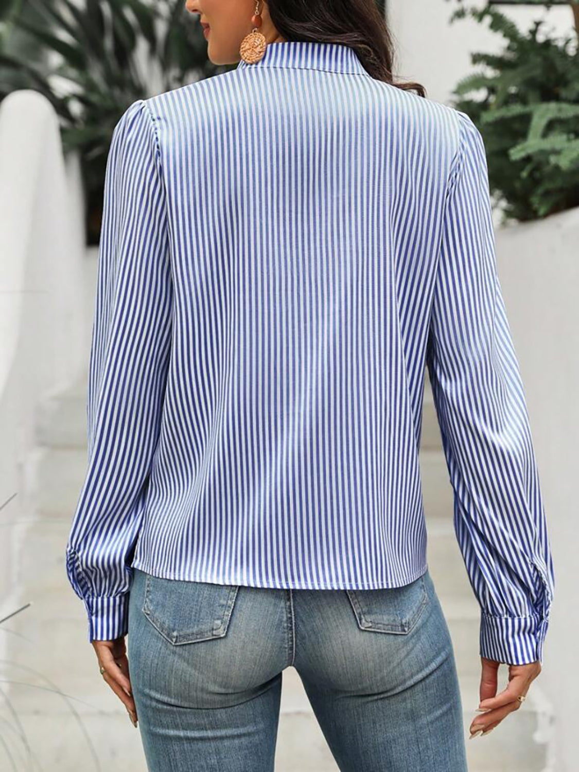 Light blue and white striped blouse with puffed sleeves and a keyhole neckline.